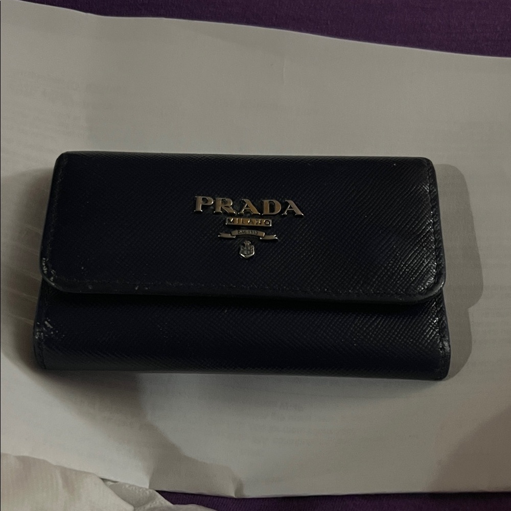Prada Midnight Leather Wallet
Has very little sign of  that's why the low price